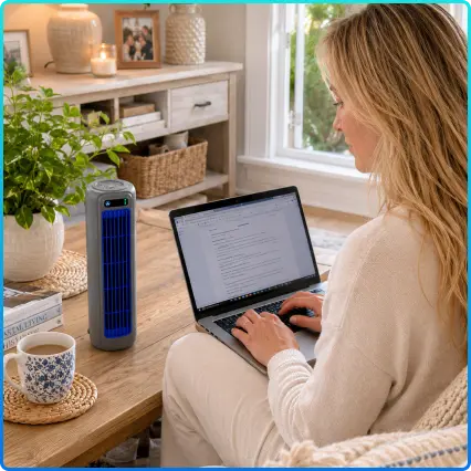 Woman working from home with SaviChill personal cooling device on desk