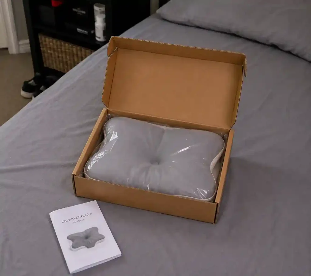 ArcaPillow unboxing with ergonomic pillow and user manual.